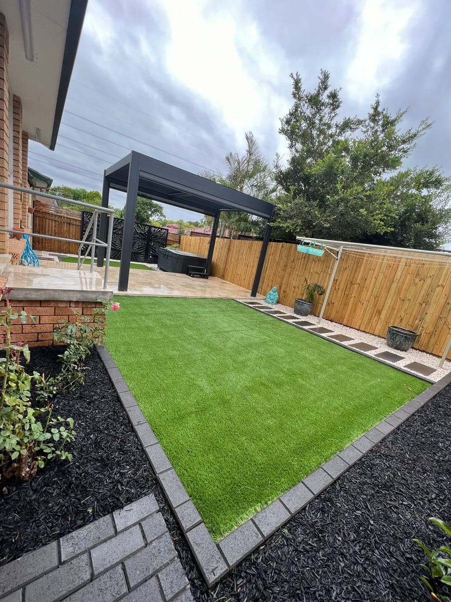 Dark garden edging defining an artificial lawn in Balmain