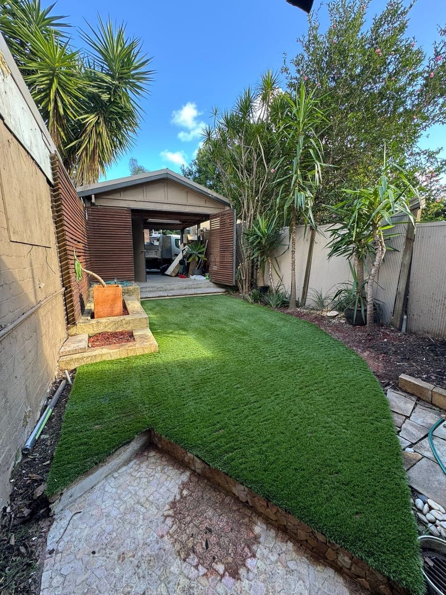 Artificial lawn fitted around garden beds in a Camperdown courtyard
